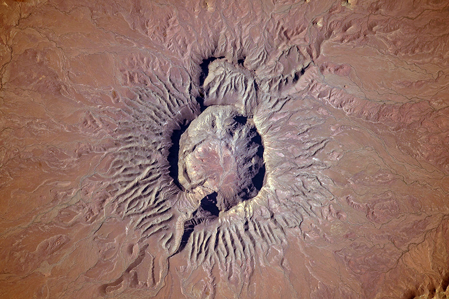 Brukkaros Mountain, an extinct volcano rising out of the desert in the ǁKaras Region of southern Namibia. Some four kilometres wide, Brukkaros was formed by a single volcanic event when a plug of rising superheated magma met groundwater 80-million years ago, causing a massive explosion and creating what looks like an ordinary volcanic crater.