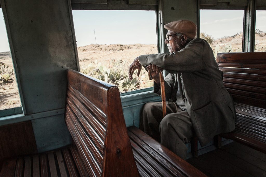 Africa - A man looks out from a carriage on the Eritrean railway line between the capital of Asmara and the coastal city of Massawa