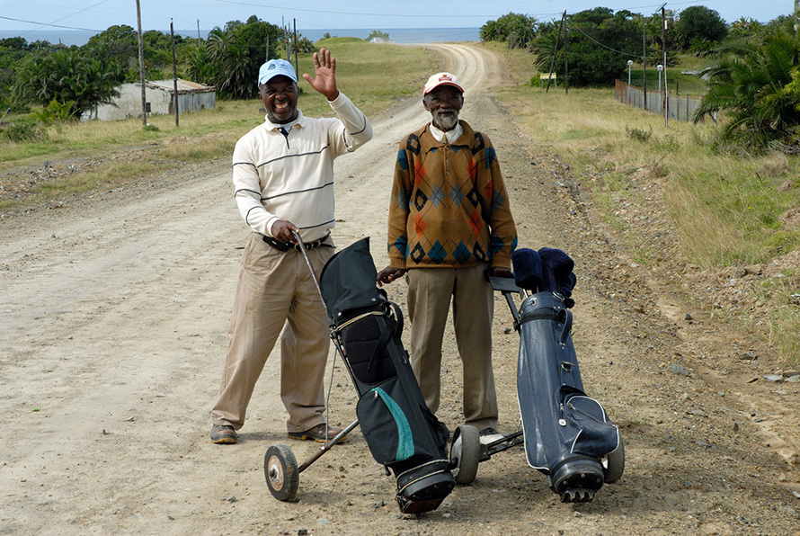 Avid golfers Welcome Tolbadi (18 handicap) and Dickson Mboyi (10 handicap) head off for a round at the nine-hole golf course in the Wild Coast village of Qolora Mouth in the Eastern Cape. (Rodger Bosch, Media Club South Africa)