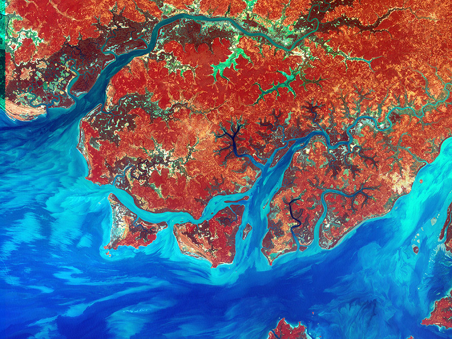 A false-colour composite satellite image of the rivers, coast and islands of Guinea-Bissau. Infrared, red and blue light wavelengths bring out details of the complex patterns of the country's shallow coastal waters, where silt carried by the Geba and other rivers washes out into the Atlantic Ocean.