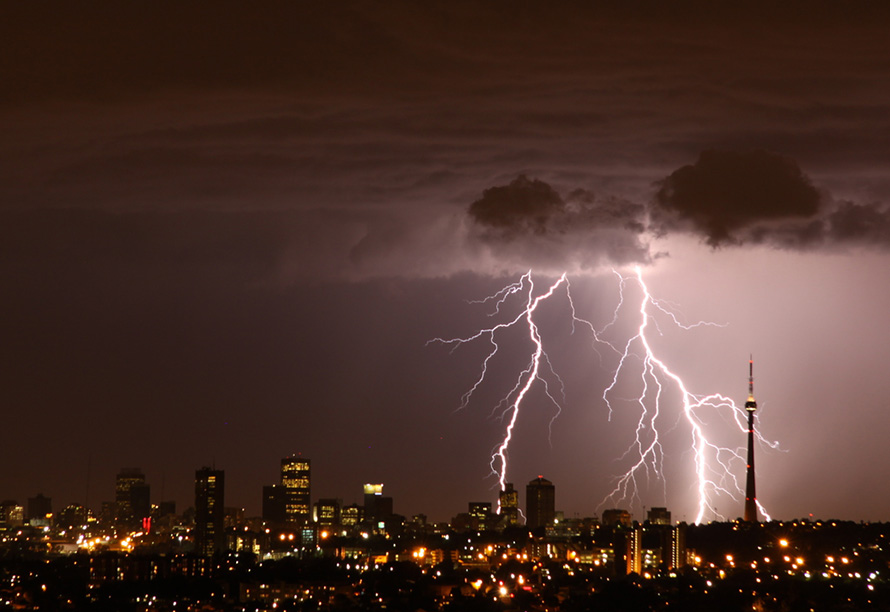 The clouds and lightning of a summertime thunderstorm over Johannesburg. The Brixton Tower is at right, and the buildings of the city's old central business district towards the left. (Derek Keats, CC BY 2.0)