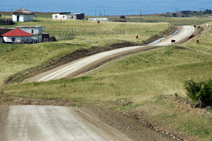 The road into the coastal village of Qolora Mouth curves past rural homesteads in the Wild Coast region of the Eastern Cape. (Rodger Bosch, Media Club South Africa)