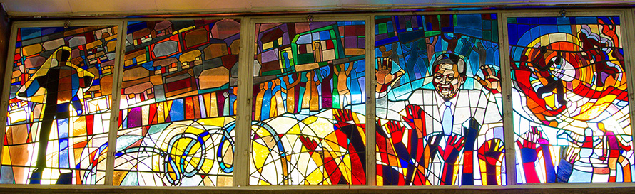 Stained glass in the famous Regina Mundi Church in Soweto shows scenes from the township's - and South Africa's - liberation history. (Willem van Valkenburg, CC BY 2.0)