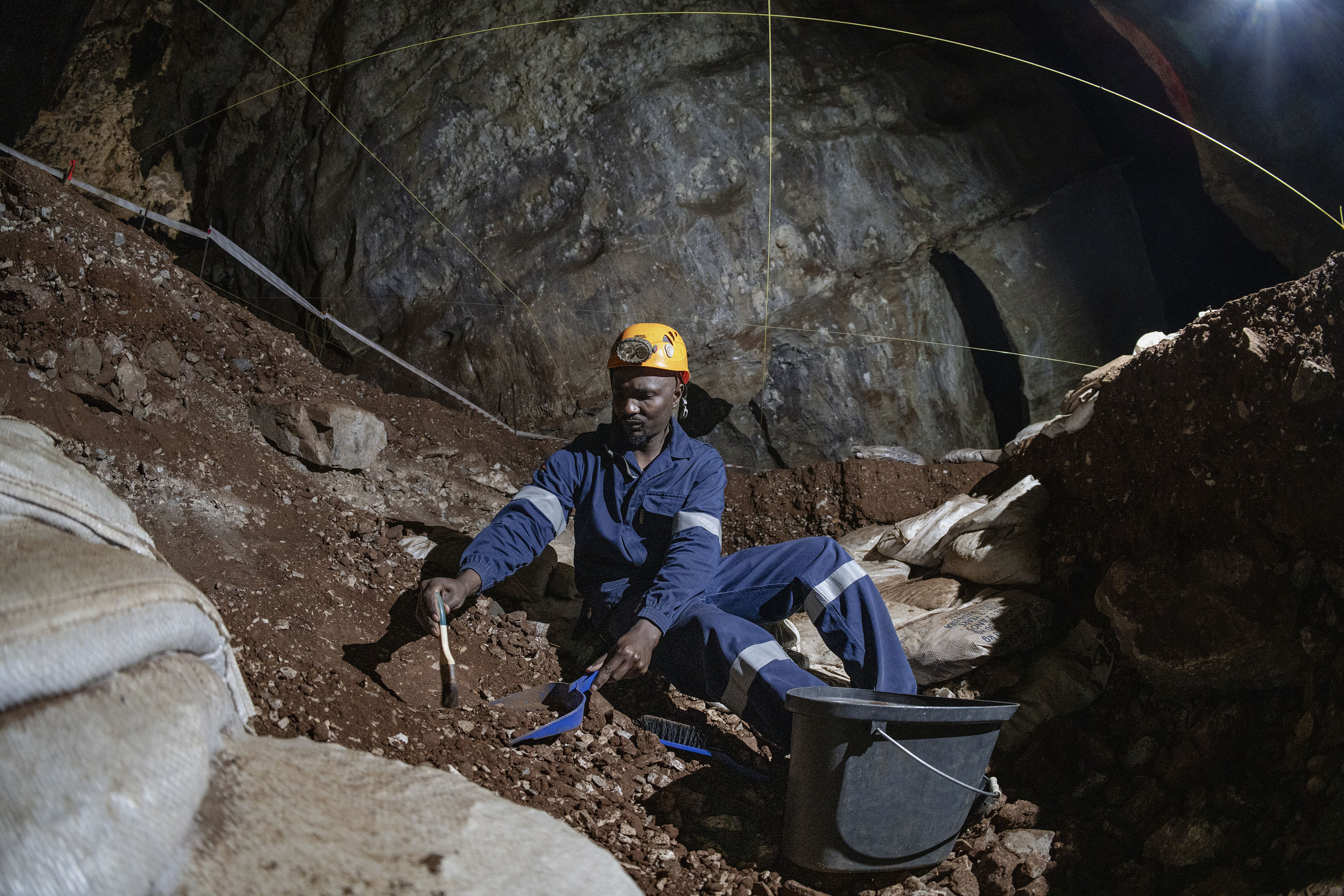 Fossil technician Itumeleng Molefe working in the Sterkfontein Caves, as his father did before him. (Photo: Ihsaan Haffejee)