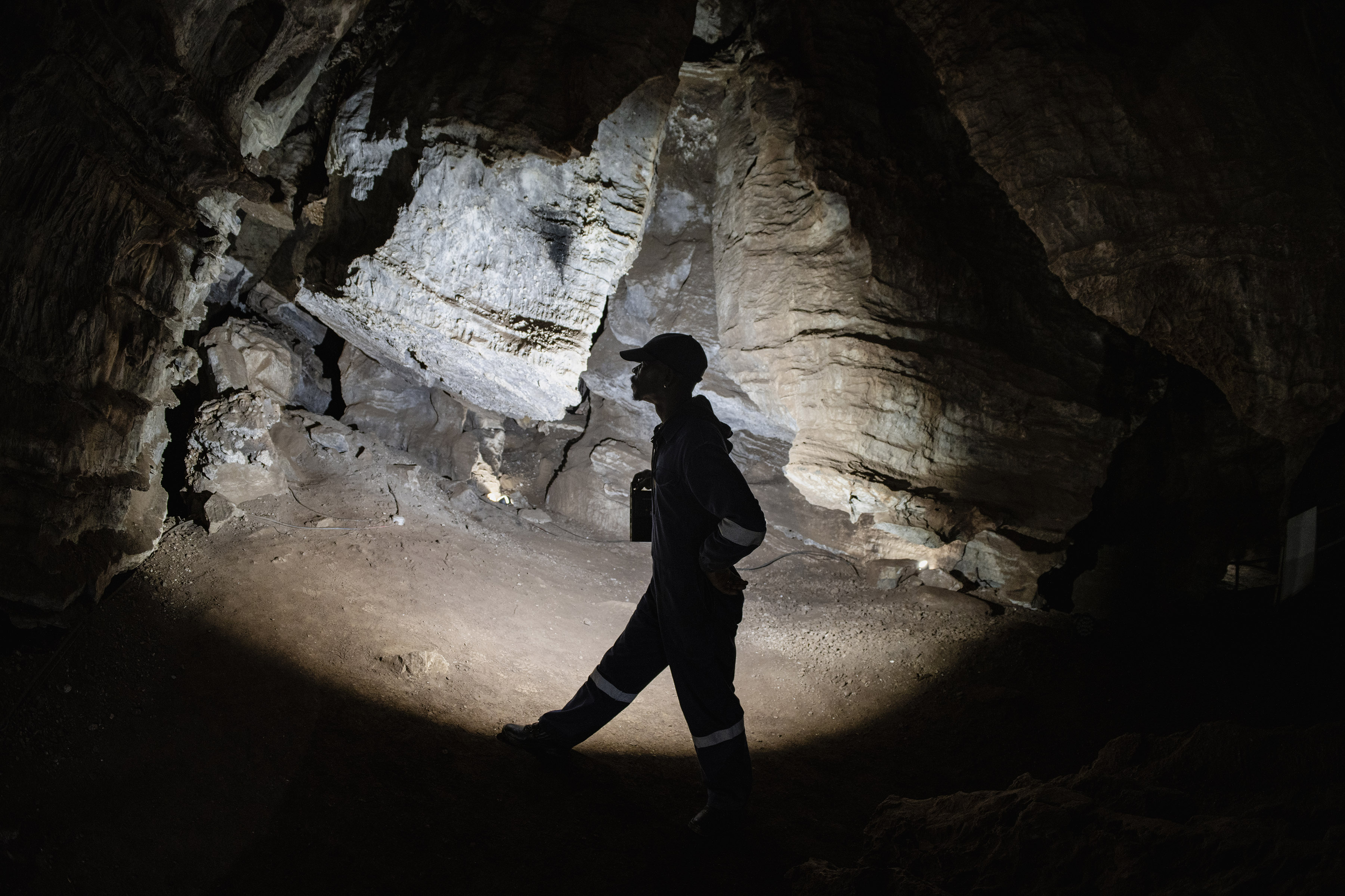 Fossil technician Sipho Makhele deep underground in the darkness of the Sterkfontein Caves near Johannesburg. The caves are part of the Cradle of Humankind, one of South Africa’s 12 Unesco World Heritage Sites. (Photo: Ihsaan Haffejee)