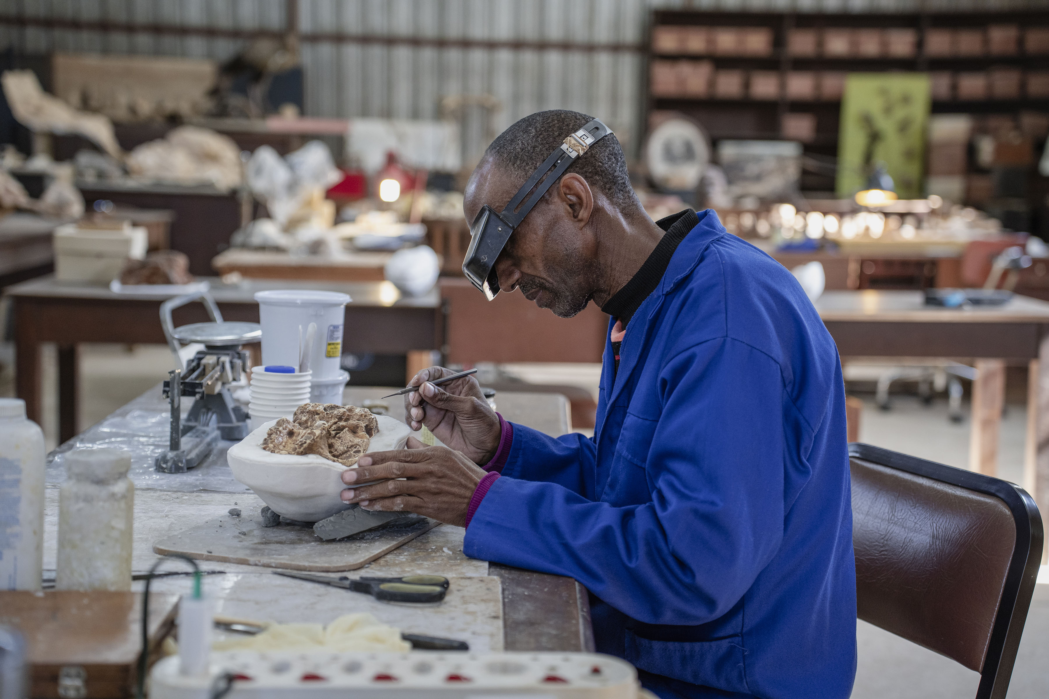 Fossil technician Abel Molepolle casting a replica of a fossil from the Sterkfontein Caves. (Photo: Ihsaan Haffejee)