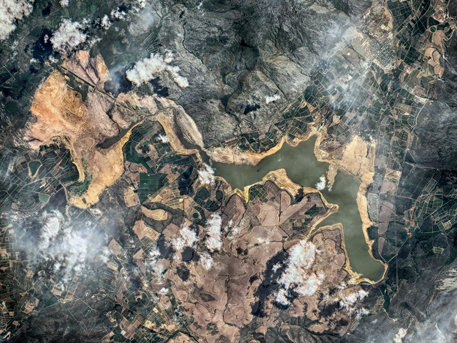A satellite image of Cape Town's Theewaterskloof Dam in early February 2018 shows the seriousness of the city's drought. After three successive dry years - estimated as a once in a millennium event - the dam, which supplies half the city's water, was at only 13% capacity. (Antti Lipponen, CC BY 2.0)